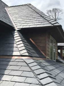 Slate roof on gable end, copper flashing