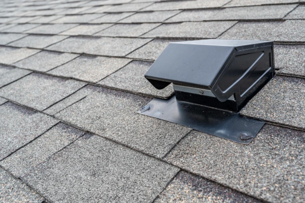 Roof ventilation vent installed on asphalt shingle roof with proper flashing